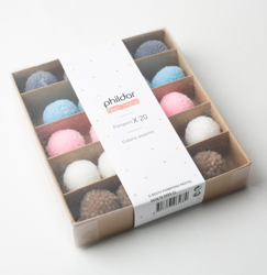 Boîte pompons pastels en oferta